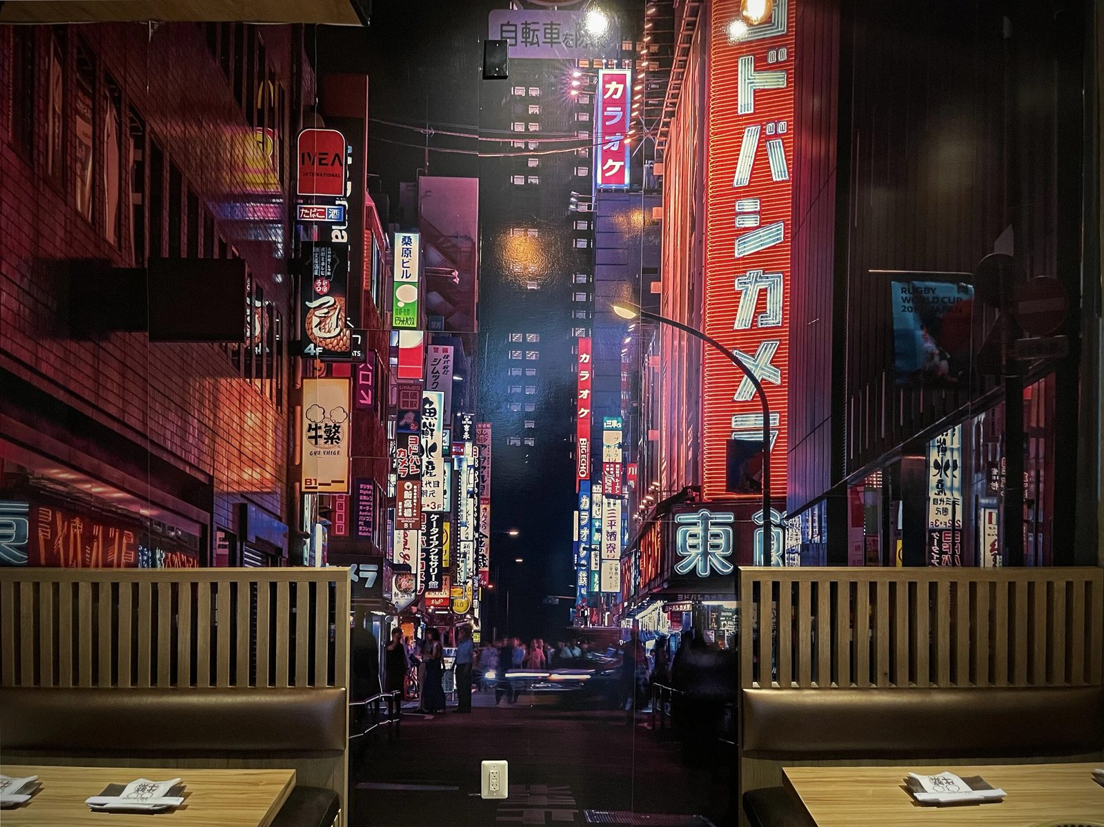 Reservados frente a un mural de una calle de Tokio en el comedor de Gyu Shige en Fairfax