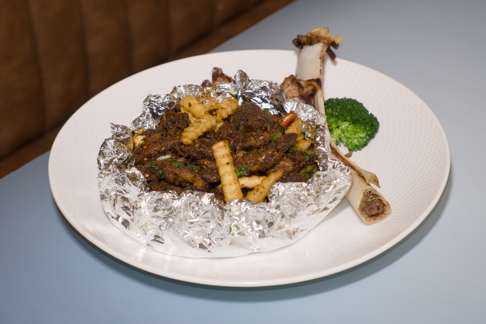 Flaming Roasted Lamb Leg on foil with the bone at Lao Sze Chuan Baltimore
