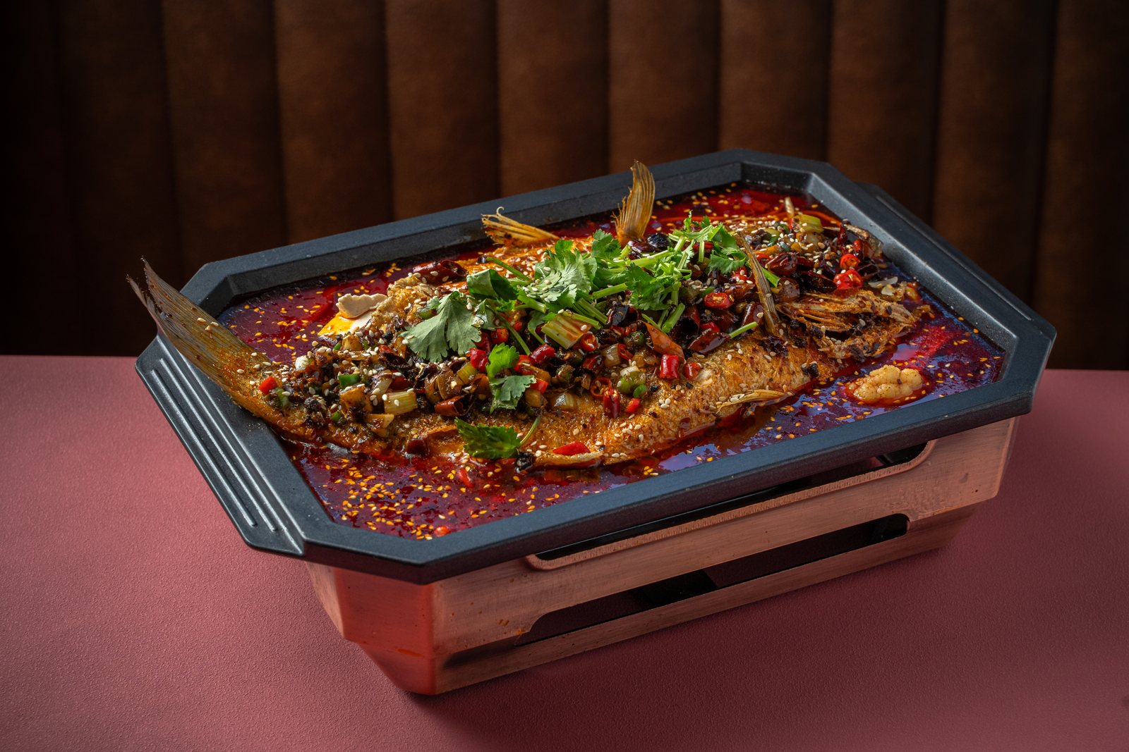 Sichuan Roasted European Seabass in chili oil over a tabletop burner