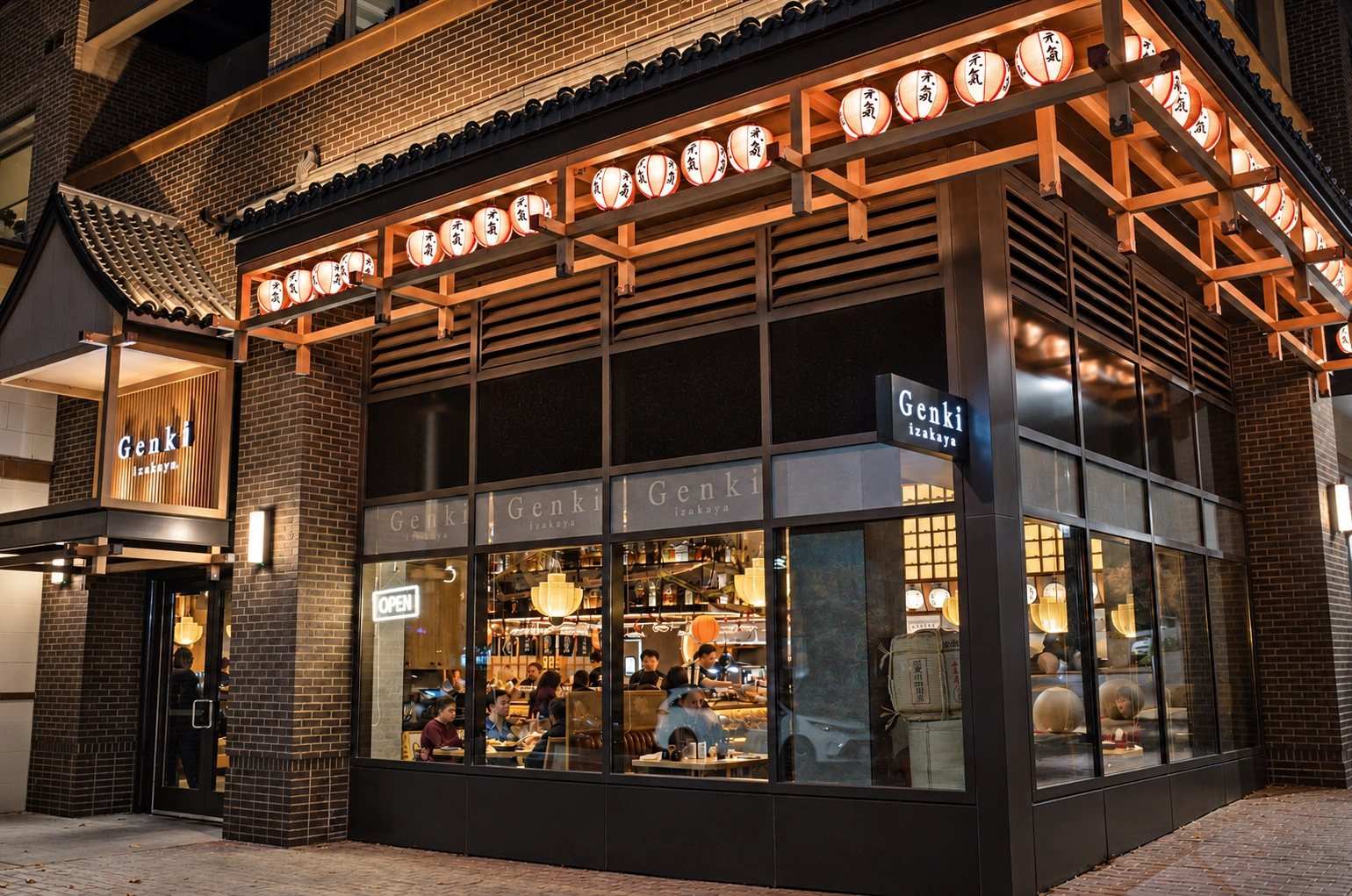 La fachada de Genki Izakaya iluminada con faroles de noche en Fairfax, VA