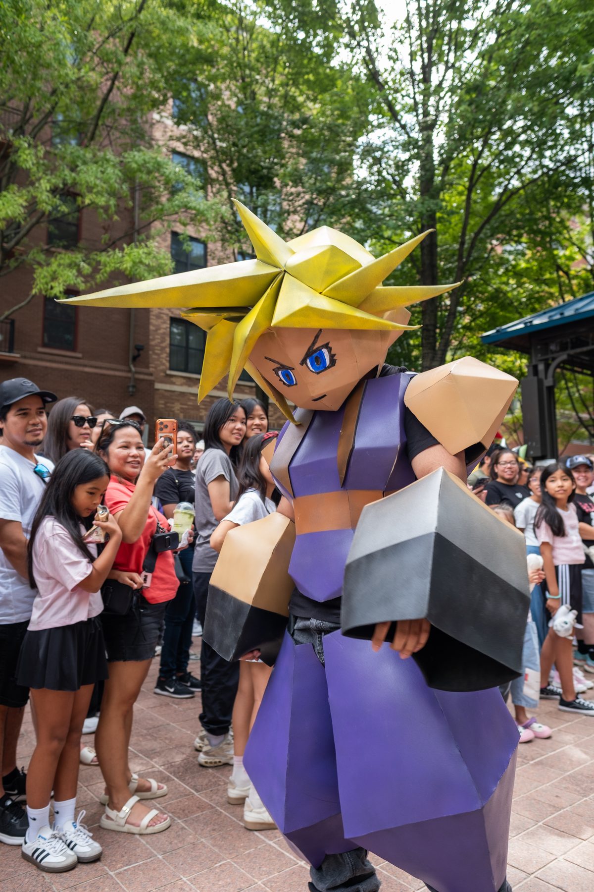 A cosplayer in a giant blocky video game hero costume walks the cosplay runway