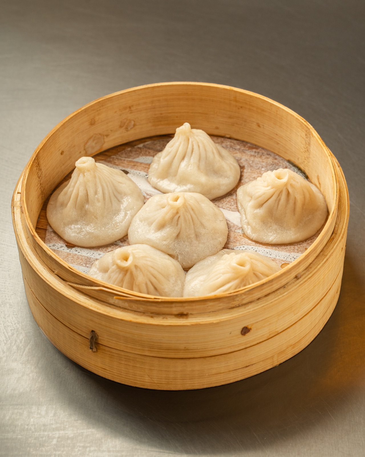 Pork soup dumplings (xiao long bao) in a bamboo steamer