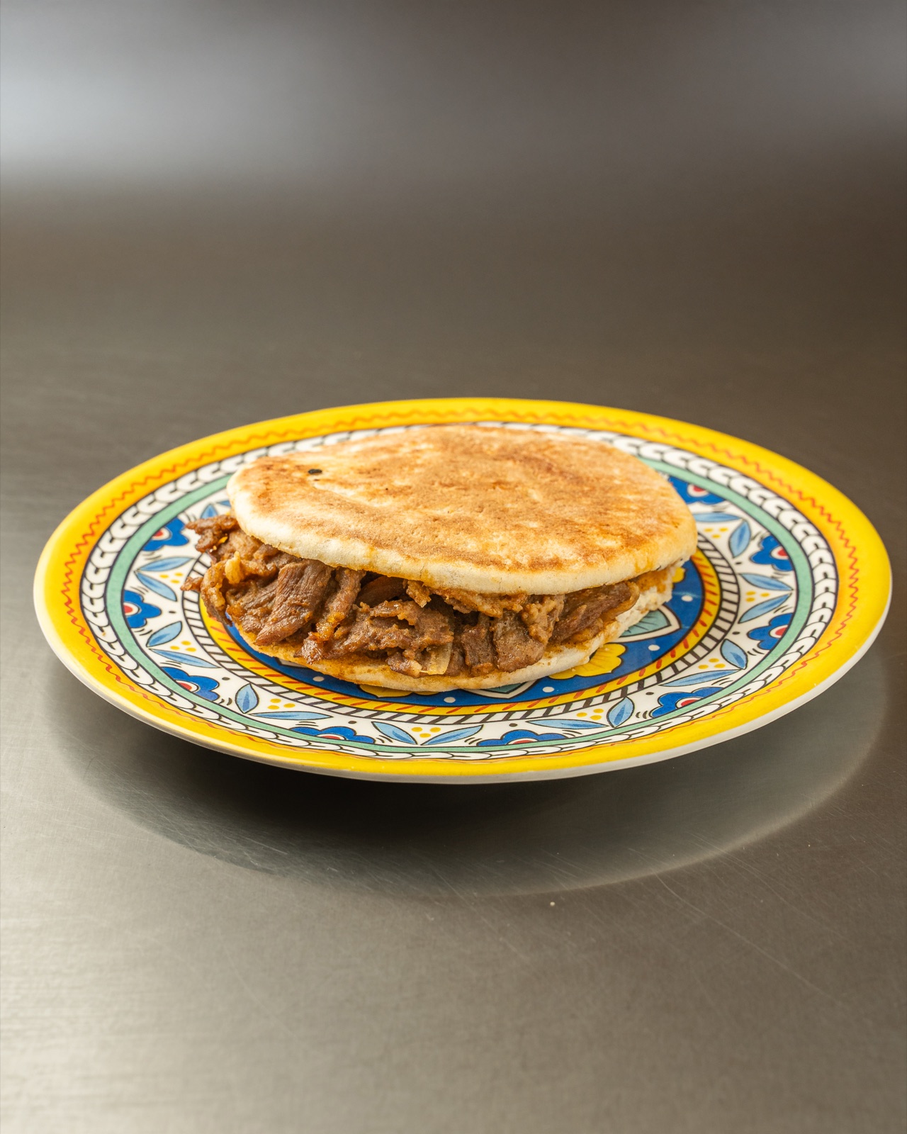 A Chinese stewed burger (rou jia mo) of braised meat in a crisp flatbread