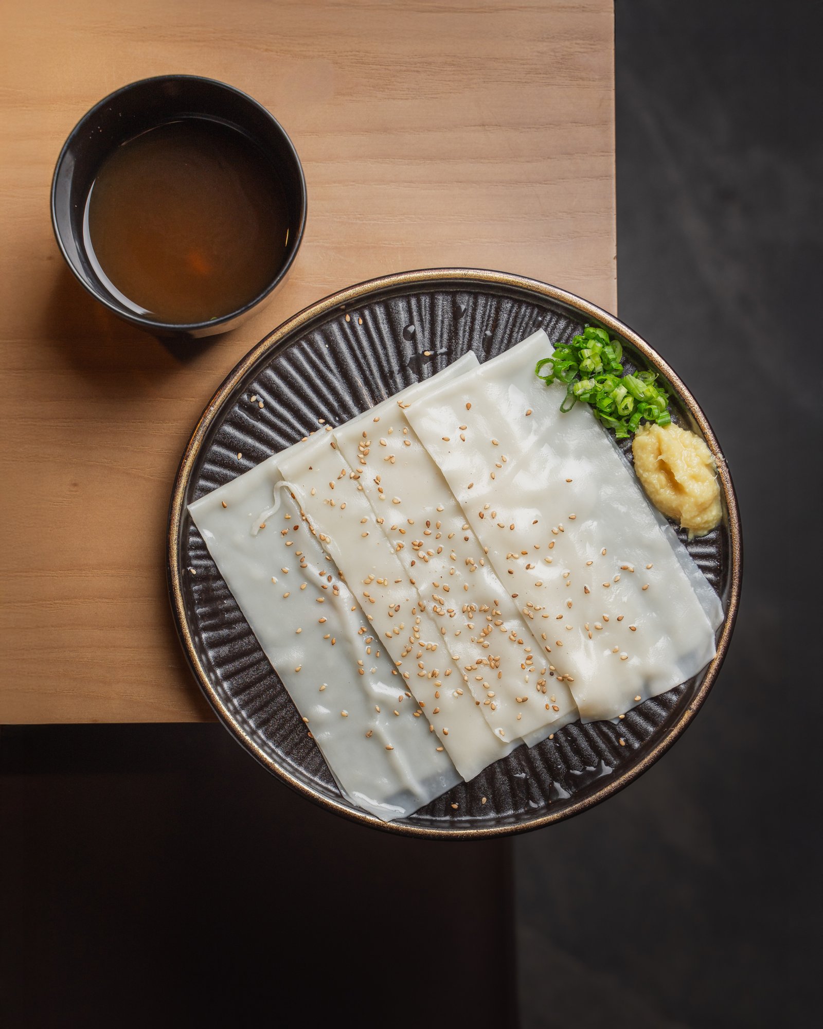 Handmade wide flat udon sheets with sesame, green onion and ginger at Gyu San in Columbia, Maryland