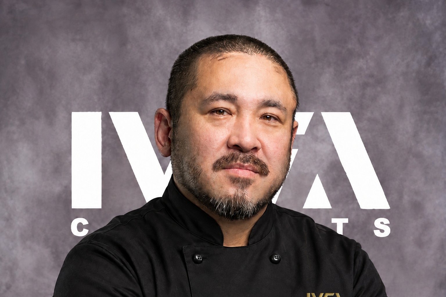 Chef Junzo Miyajima in a black chef's jacket, arms crossed